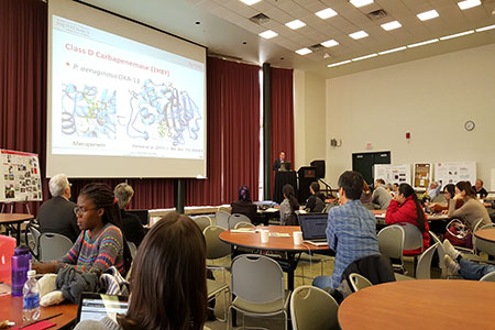 Students and faculty at a symposium.