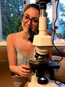 Julia Van Etten at a microscope.