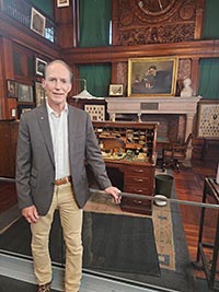 A persons tanding in front of an Edison Museum exhibit.