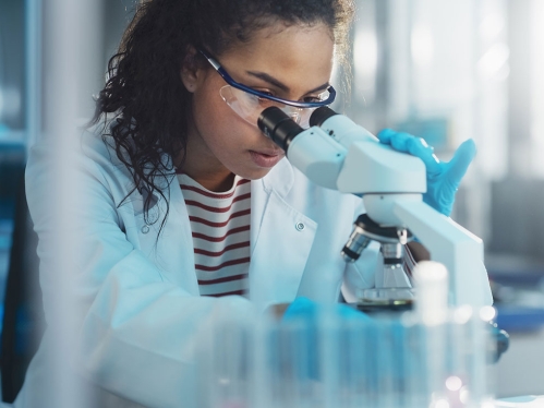 Student researcher looking in microscope