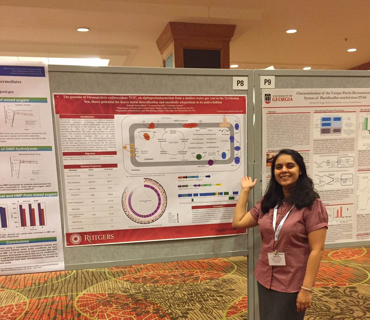 Sushmita Patwardhan standing next to a poster.